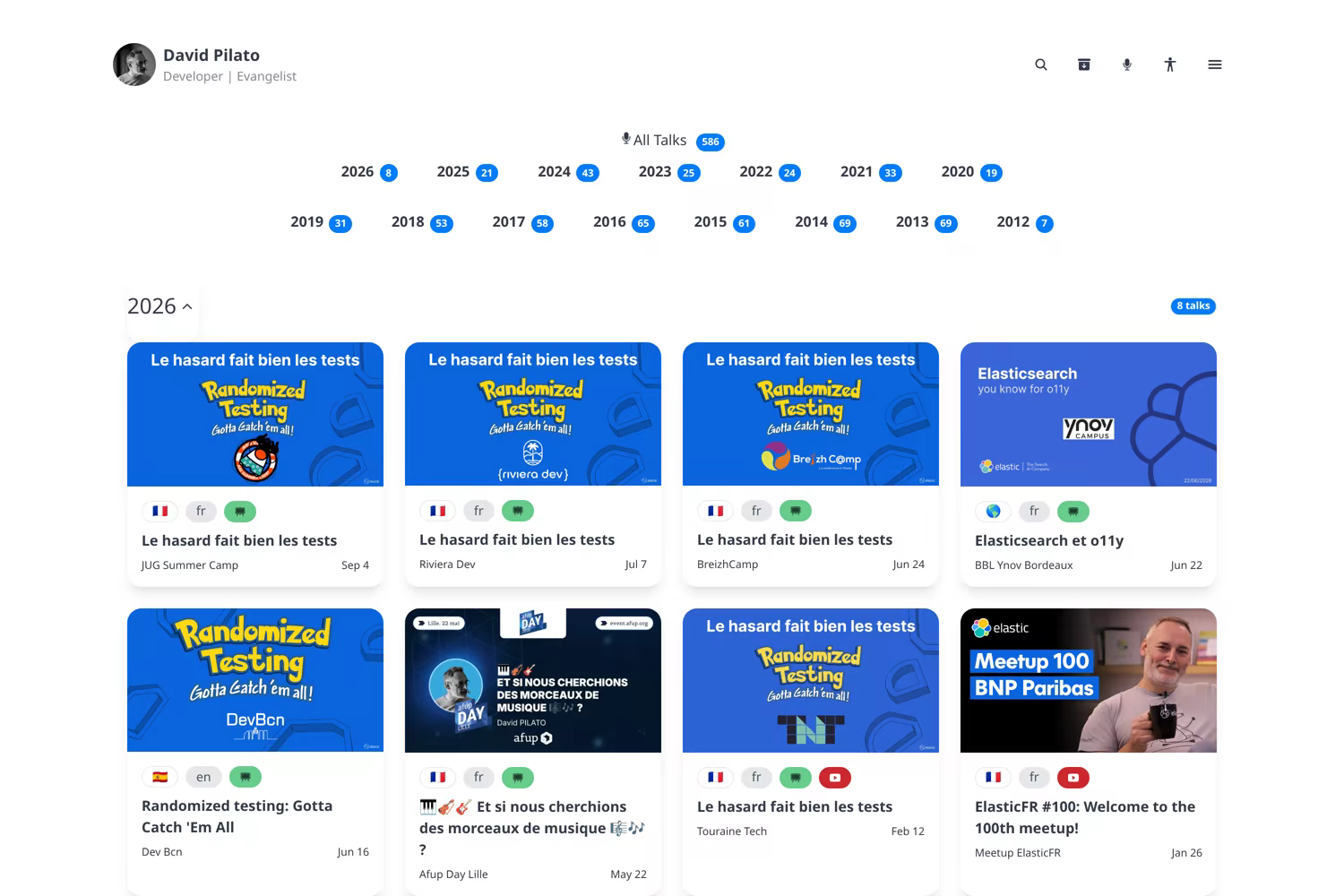 /talks/all — year navigation and the 2026 card grid. Badges tell you if slides or a recording exist.